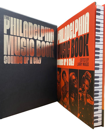 Two books titled 'The Philadelphia Music Book' and 'Sounds of a City' on a shelf.