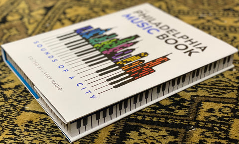 Book titled 'Philadelphia Music Book: Sounds of a City' on a textured surface